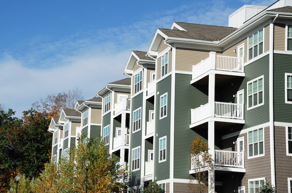 apartment building with autumn trees landscape